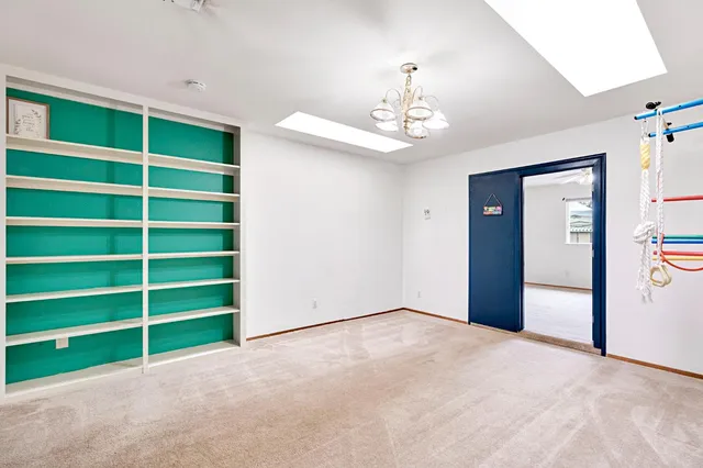 a view of an empty room with a ceiling fan