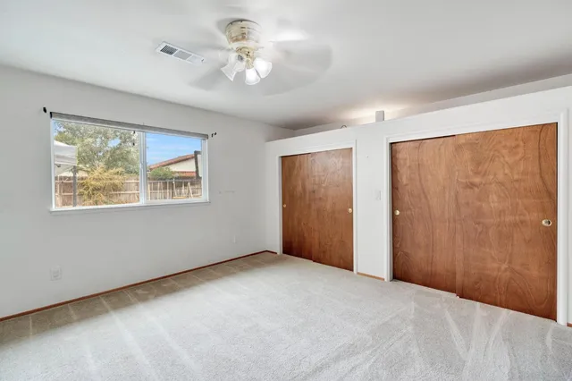 a view of a livingroom with a chandelier fan