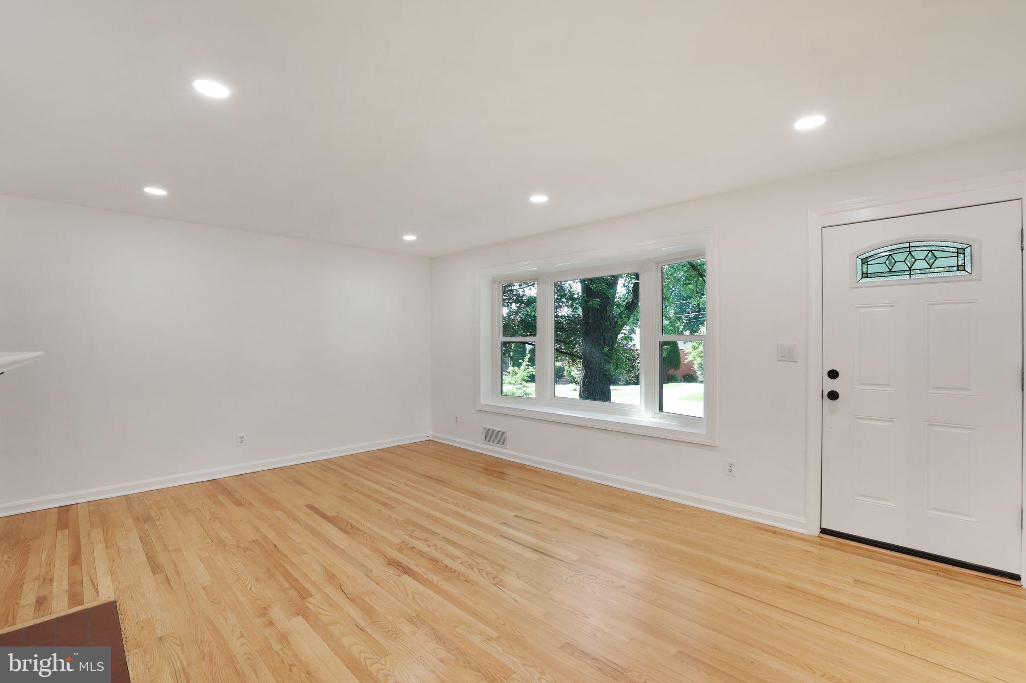 2423 Homestead Drive Silver Spring, MD 20902 - Photo 13 of 45 an empty room with wooden floor and windows