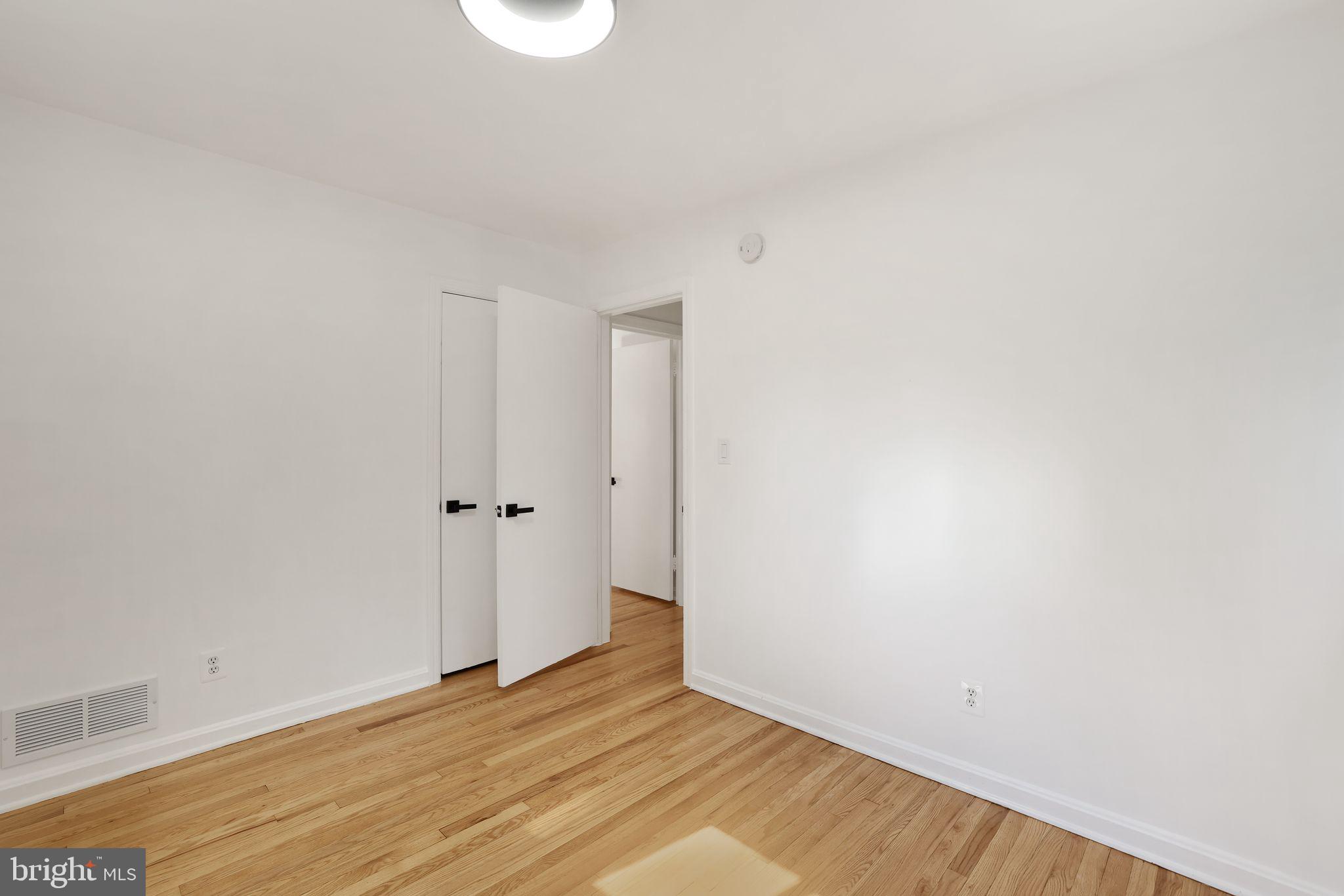 2423 Homestead Drive Silver Spring, MD 20902 - Photo 18 of 45 a view of an empty room with wooden floor and a window