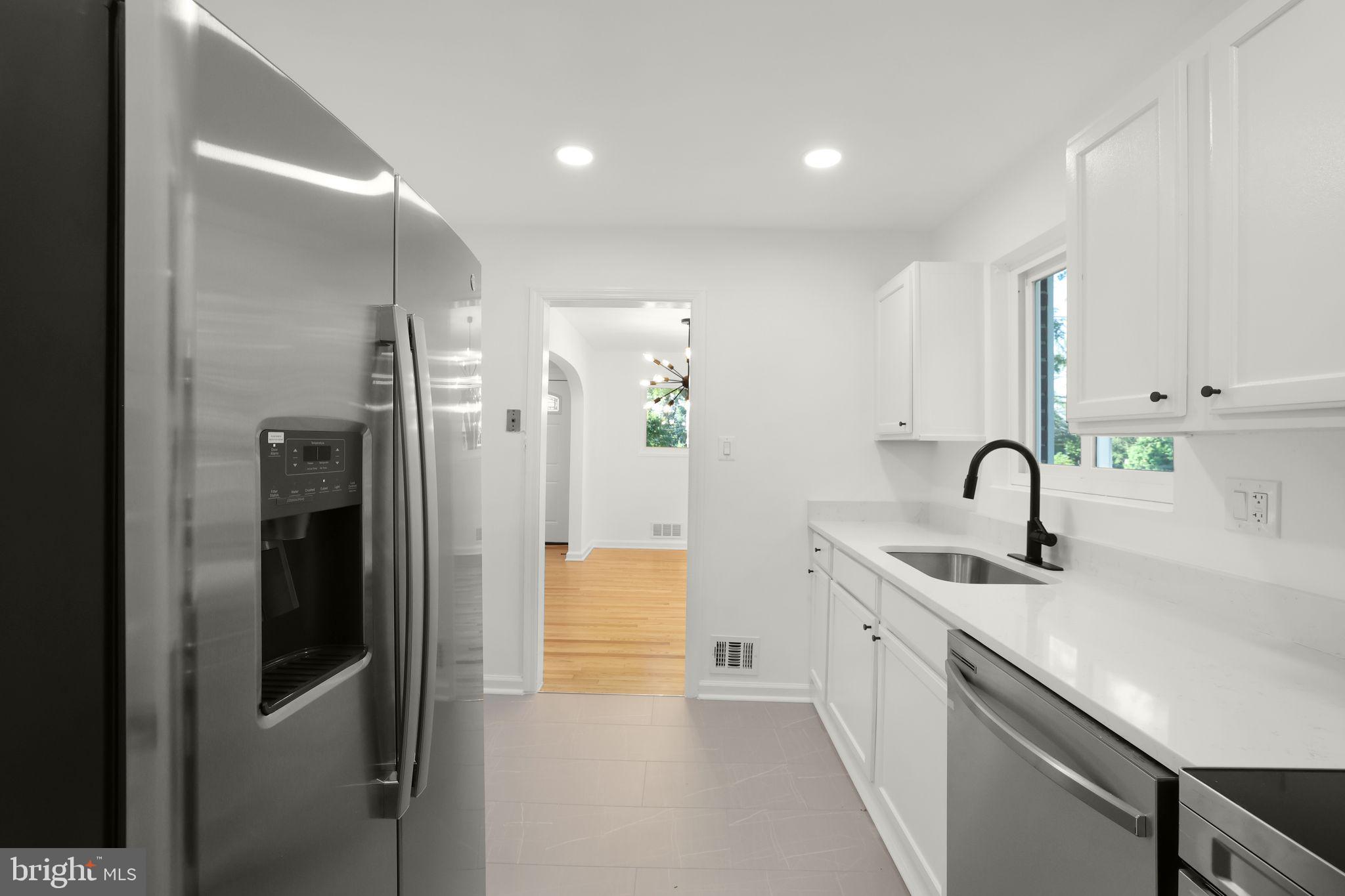 2423 Homestead Drive Silver Spring, MD 20902 - Photo 29 of 45 a kitchen with stainless steel appliances granite countertop a sink and cabinets