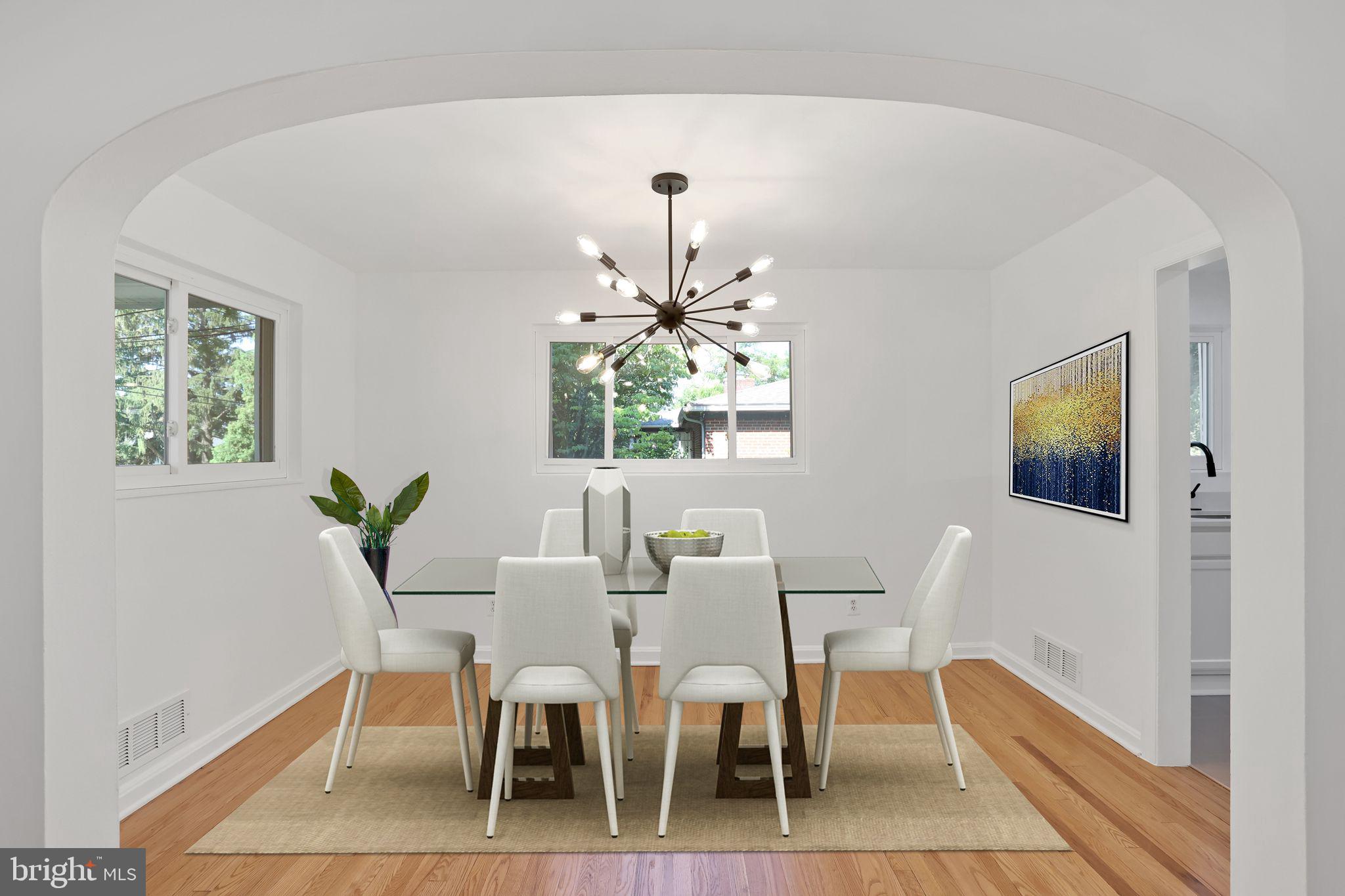 2423 Homestead Drive Silver Spring, MD 20902 - Photo 4 of 45 a dining room with furniture a potted plant and a chandelier