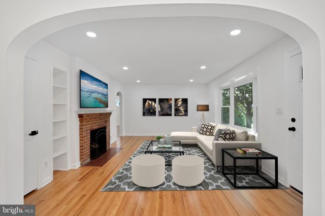 a living room with furniture a fireplace and a table