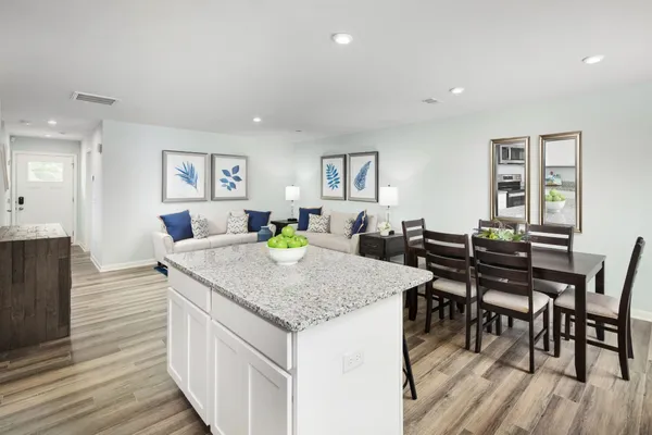 a kitchen with granite countertop a sink stove and cabinets