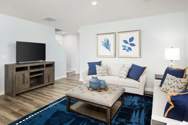 a living room with furniture and a flat screen tv