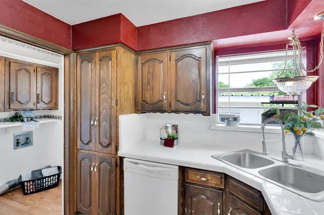 a kitchen with a sink cabinets and window