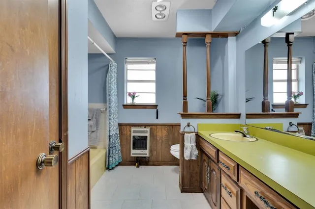 a bathroom with a sink bathtub and a mirror