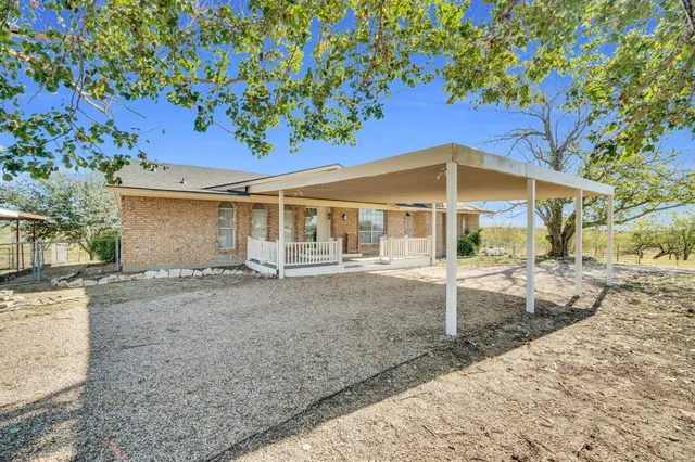 a view of a house with a yard and tree
