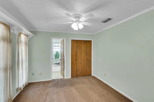 an empty room with fan and entrance