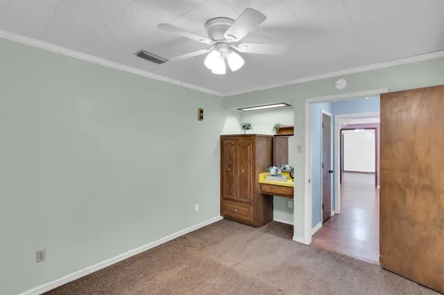 a view of an empty room with a kitchen