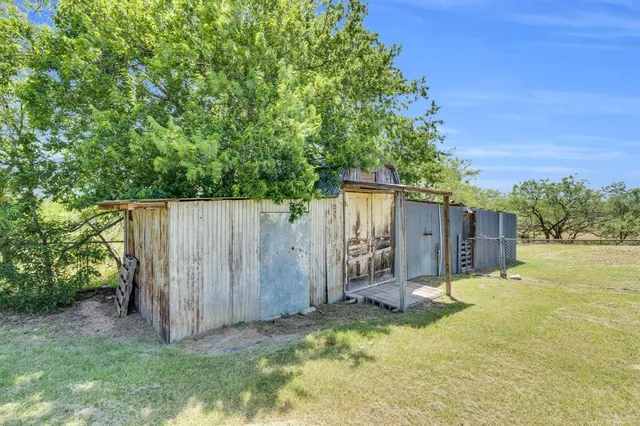 a view of a backyard with wooden fence