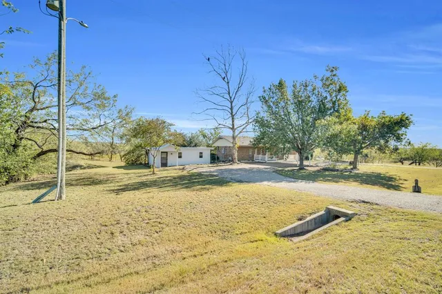 a view of a yard with swimming pool