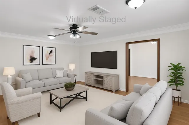 a living room with furniture a flat screen tv and a fireplace