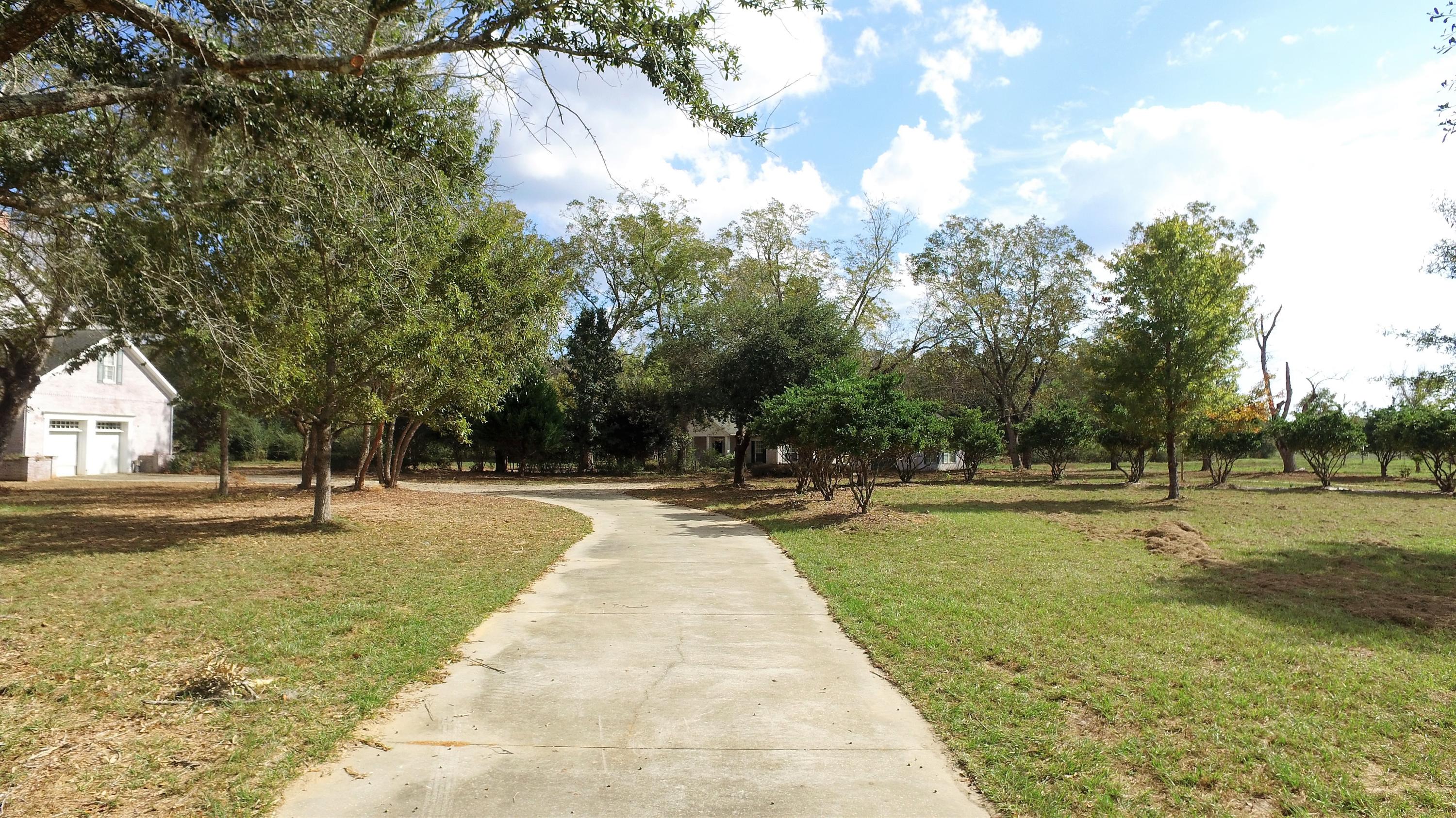 5437 Griffith Mill Road Baker, FL 32531 - Photo 28 of 100 a swimming pool with lots of tress in front of it