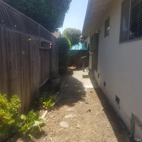 a view of a pathway with a wooden fence