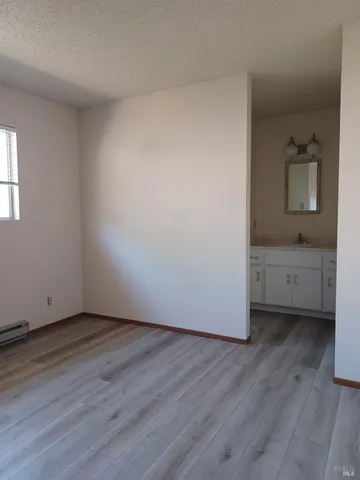 a view of an empty room and wooden floor