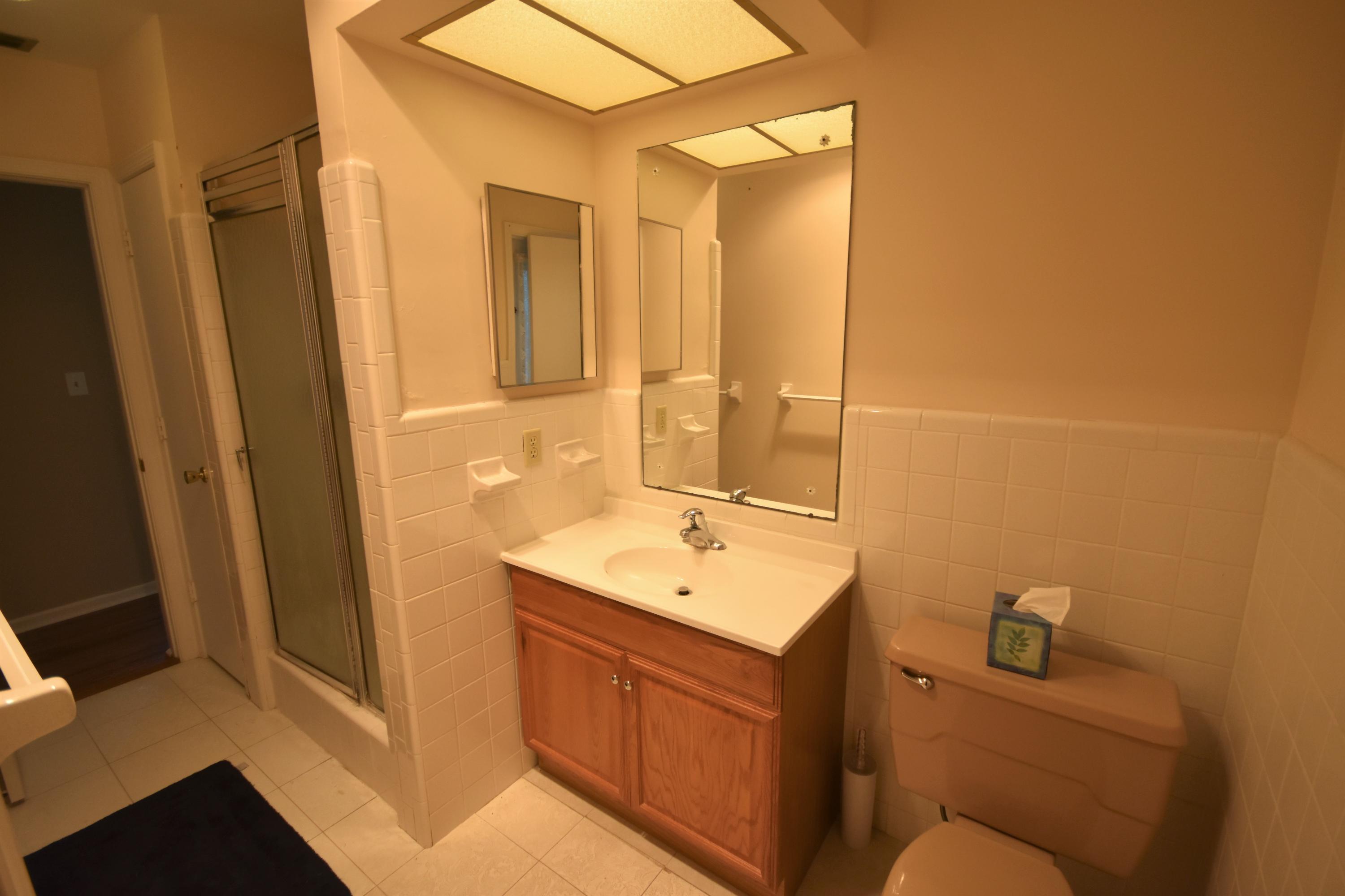 500 Northwest 12th Avenue Boca Raton, FL 33486 - Photo 16 of 23 a bathroom with a sink a toilet and mirror