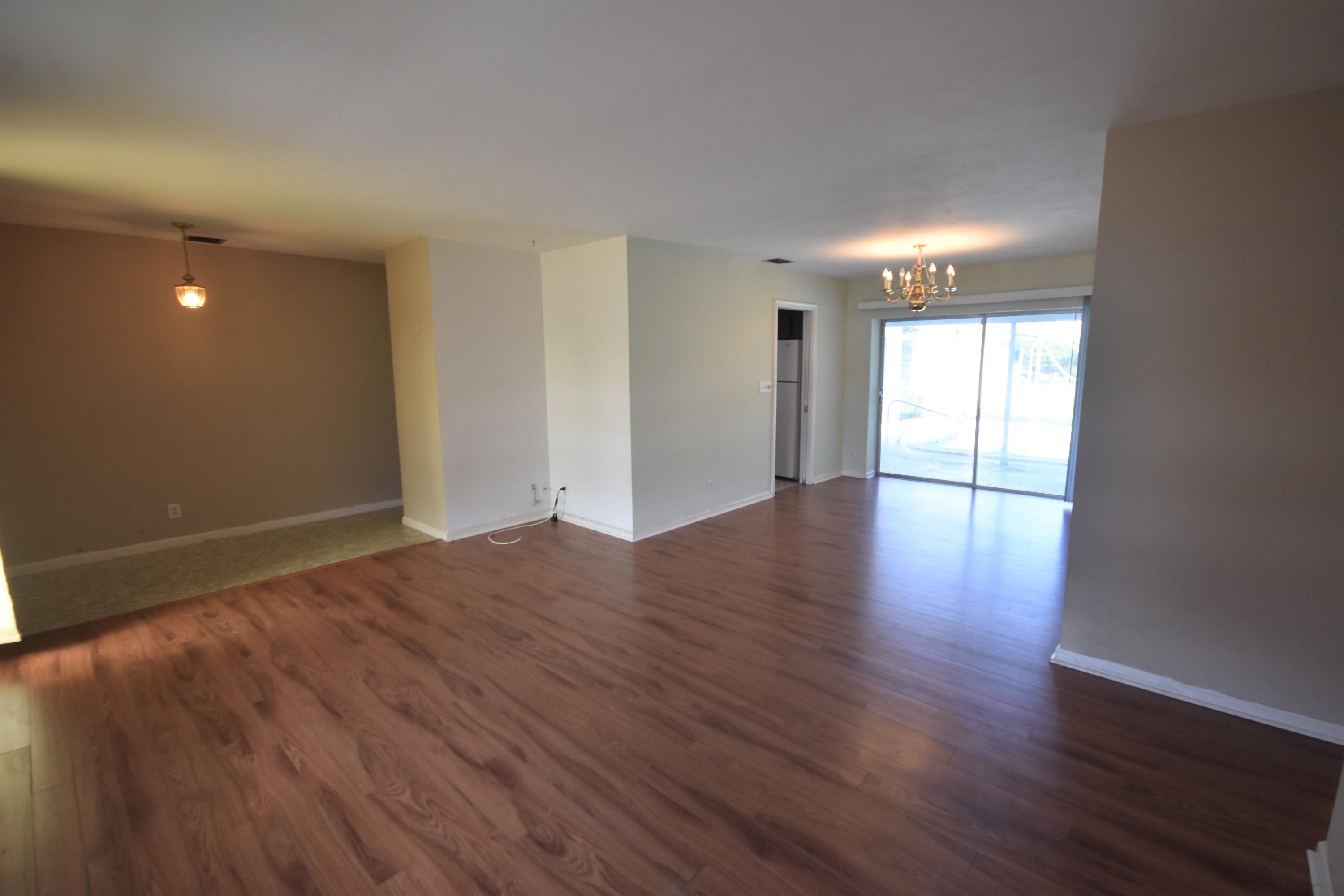 500 Northwest 12th Avenue Boca Raton, FL 33486 - Photo 3 of 23 a view of an empty room with wooden floor and windows