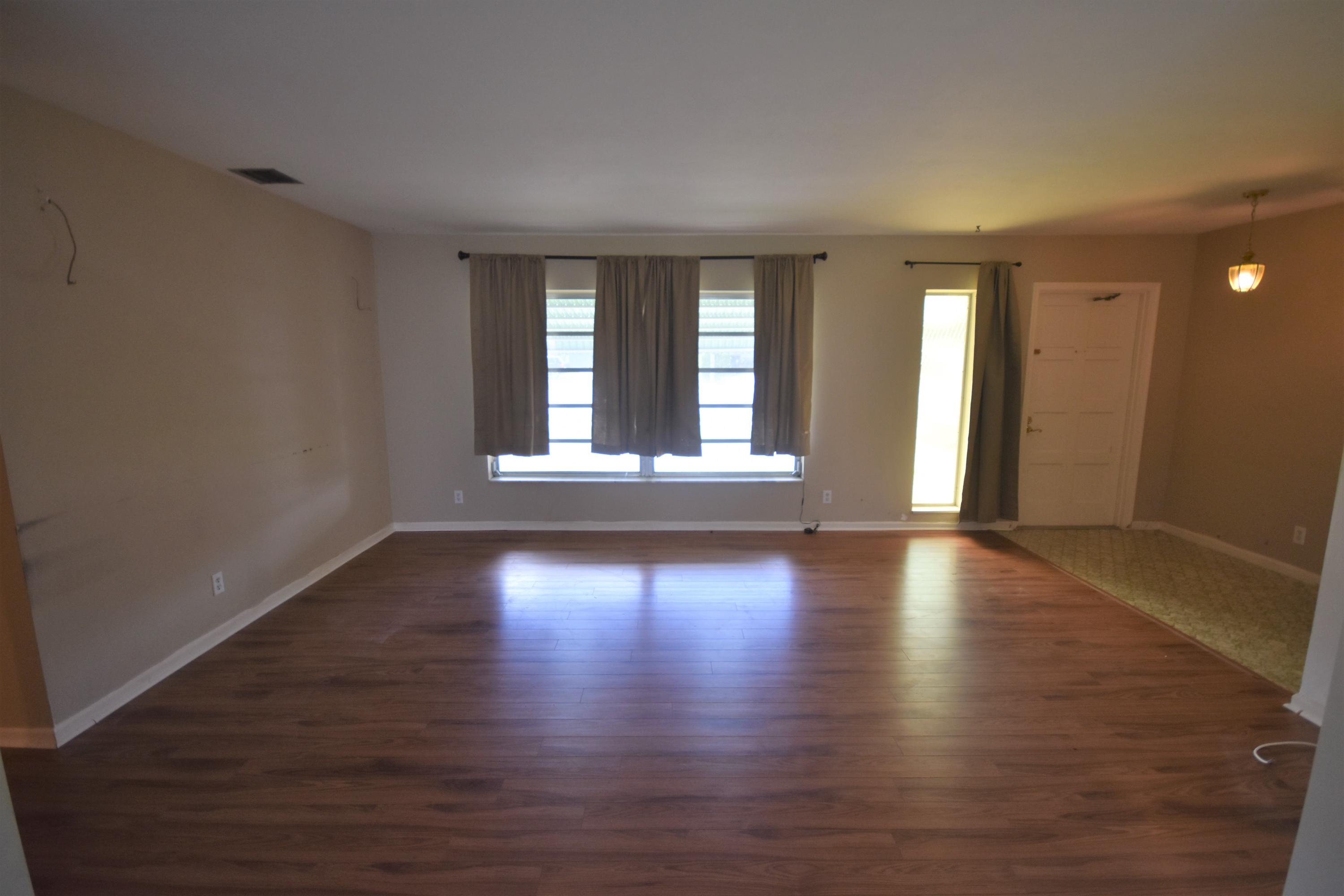 500 Northwest 12th Avenue Boca Raton, FL 33486 - Photo 4 of 23 a view of a livingroom with wooden floor and a window