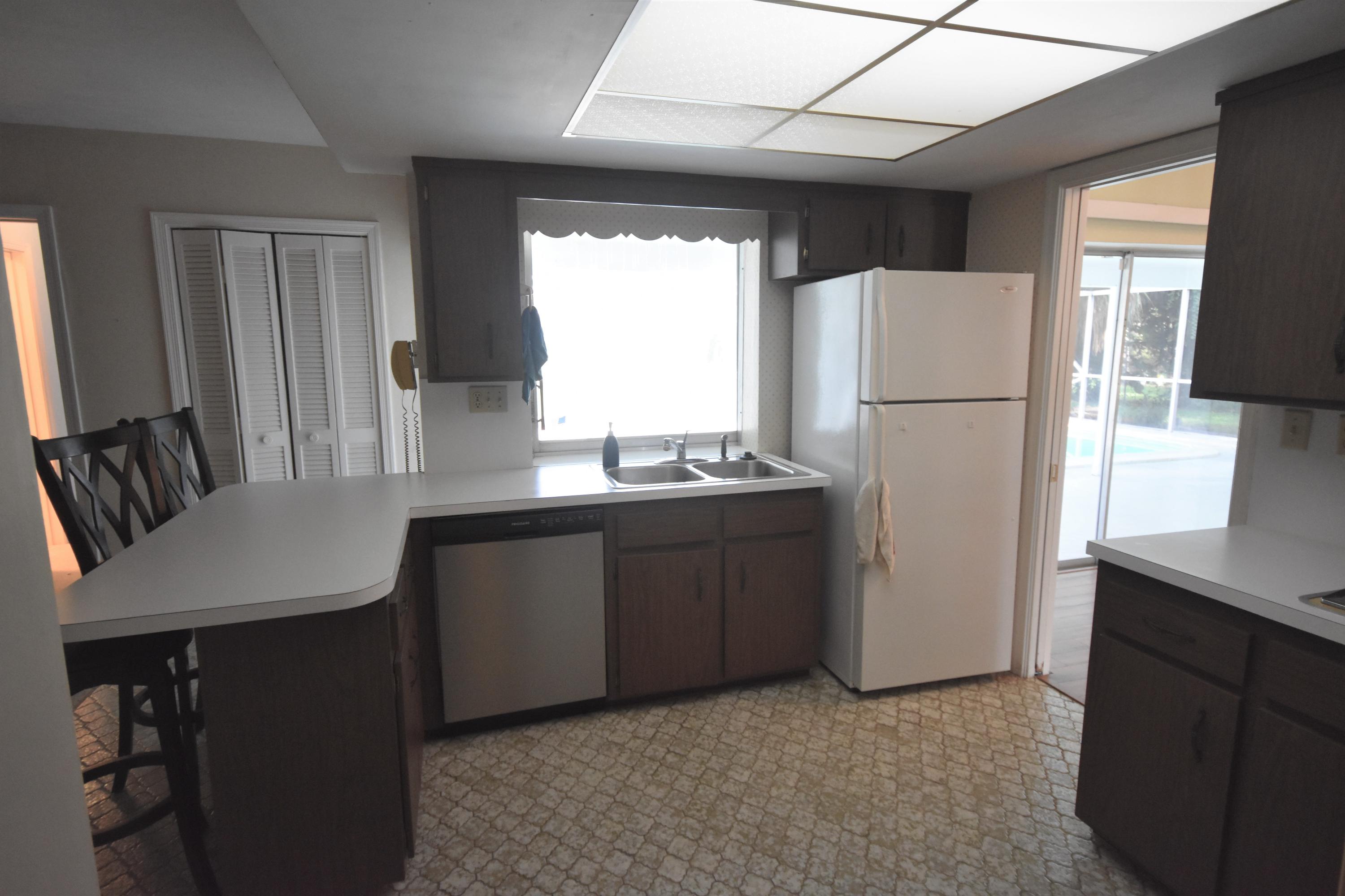 500 Northwest 12th Avenue Boca Raton, FL 33486 - Photo 6 of 23 a kitchen with sink a refrigerator and a stove