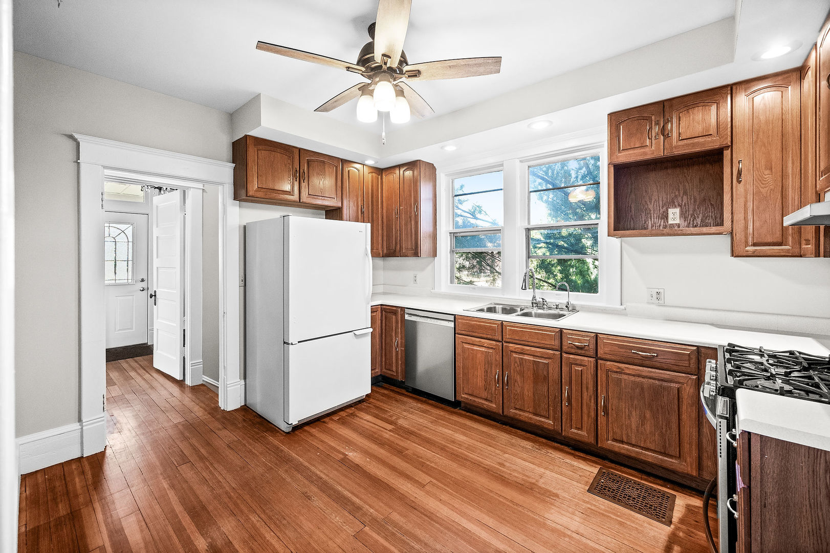 102 Vale Street Bloomington, IL 61701 - Photo 12 of 35 a kitchen with stainless steel appliances granite countertop a refrigerator a sink dishwasher a stove and white countertops with wooden floor