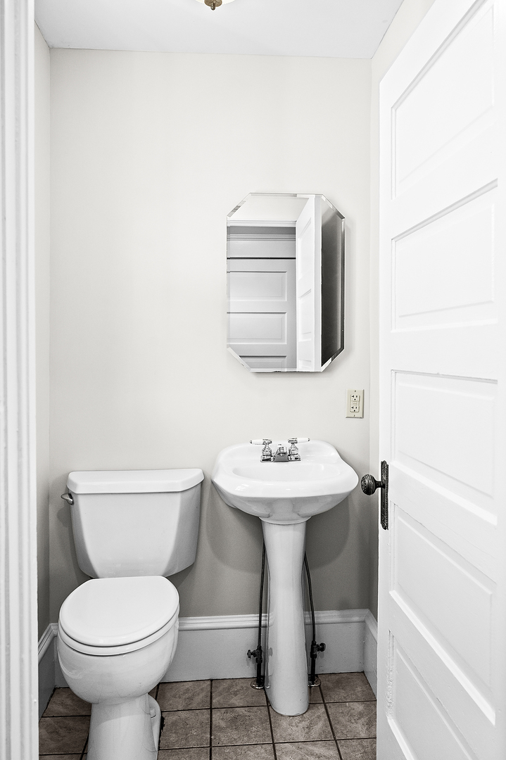 102 Vale Street Bloomington, IL 61701 - Photo 15 of 35 a bathroom with a toilet sink and mirror
