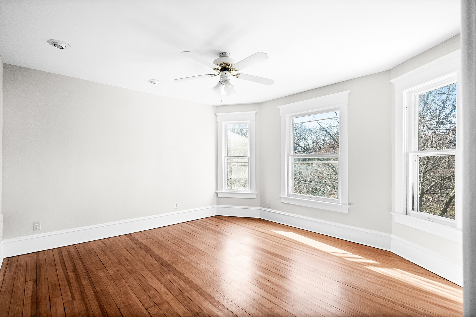 102 Vale Street Bloomington, IL 61701 - Photo 19 of 35 an empty room with wooden floor chandelier fan and windows