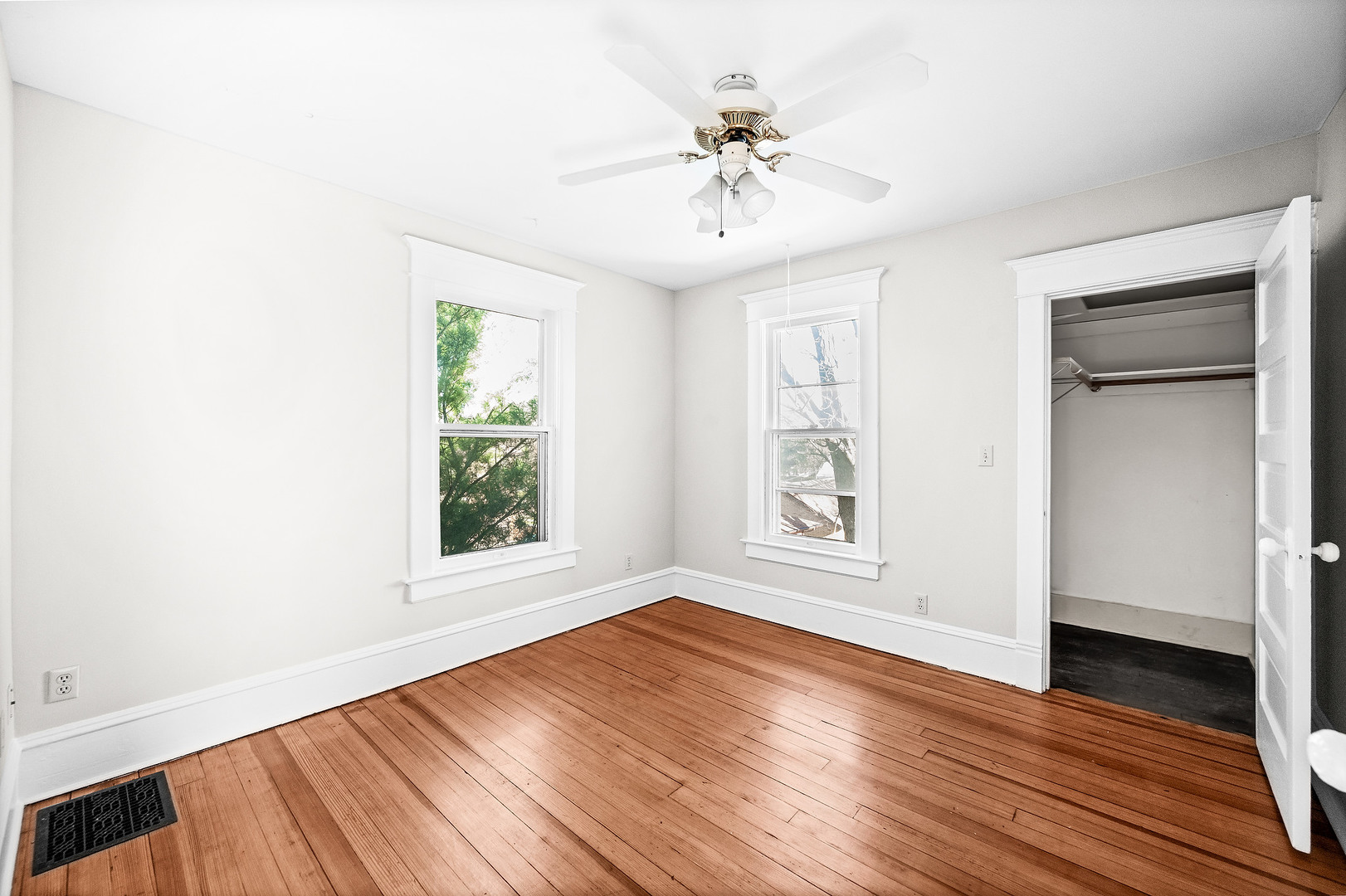 102 Vale Street Bloomington, IL 61701 - Photo 22 of 35 an empty room with wooden floor chandelier fan and windows