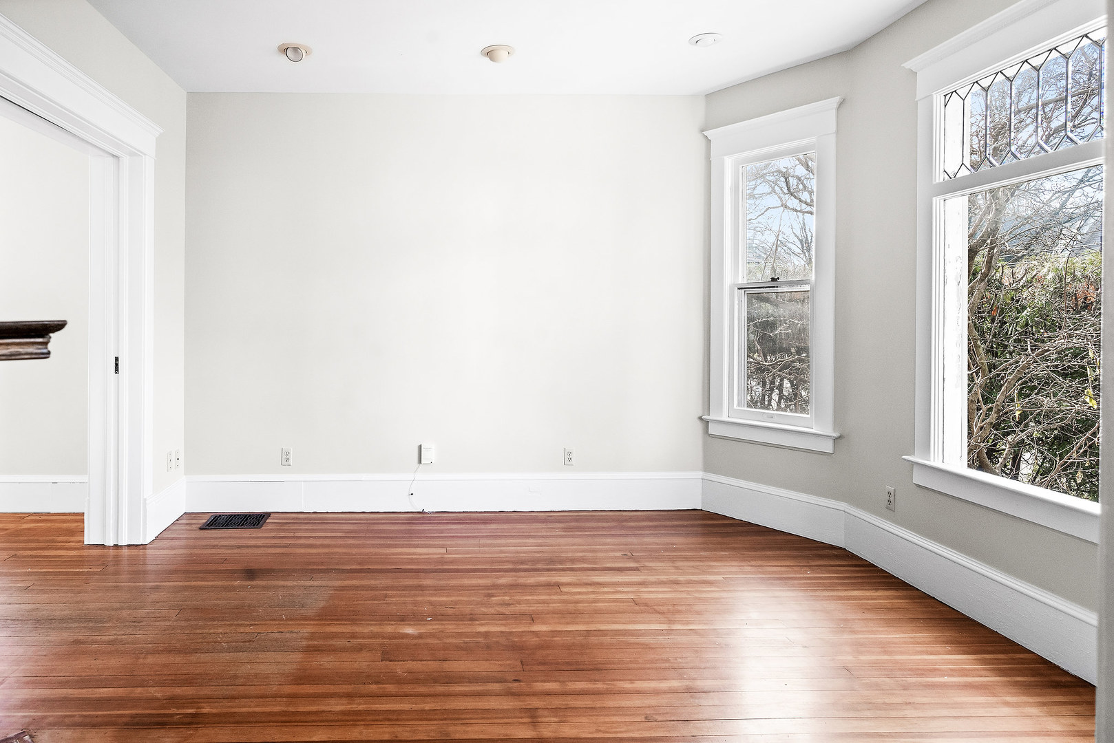 102 Vale Street Bloomington, IL 61701 - Photo 6 of 35 a view of an empty room with wooden floor and a window