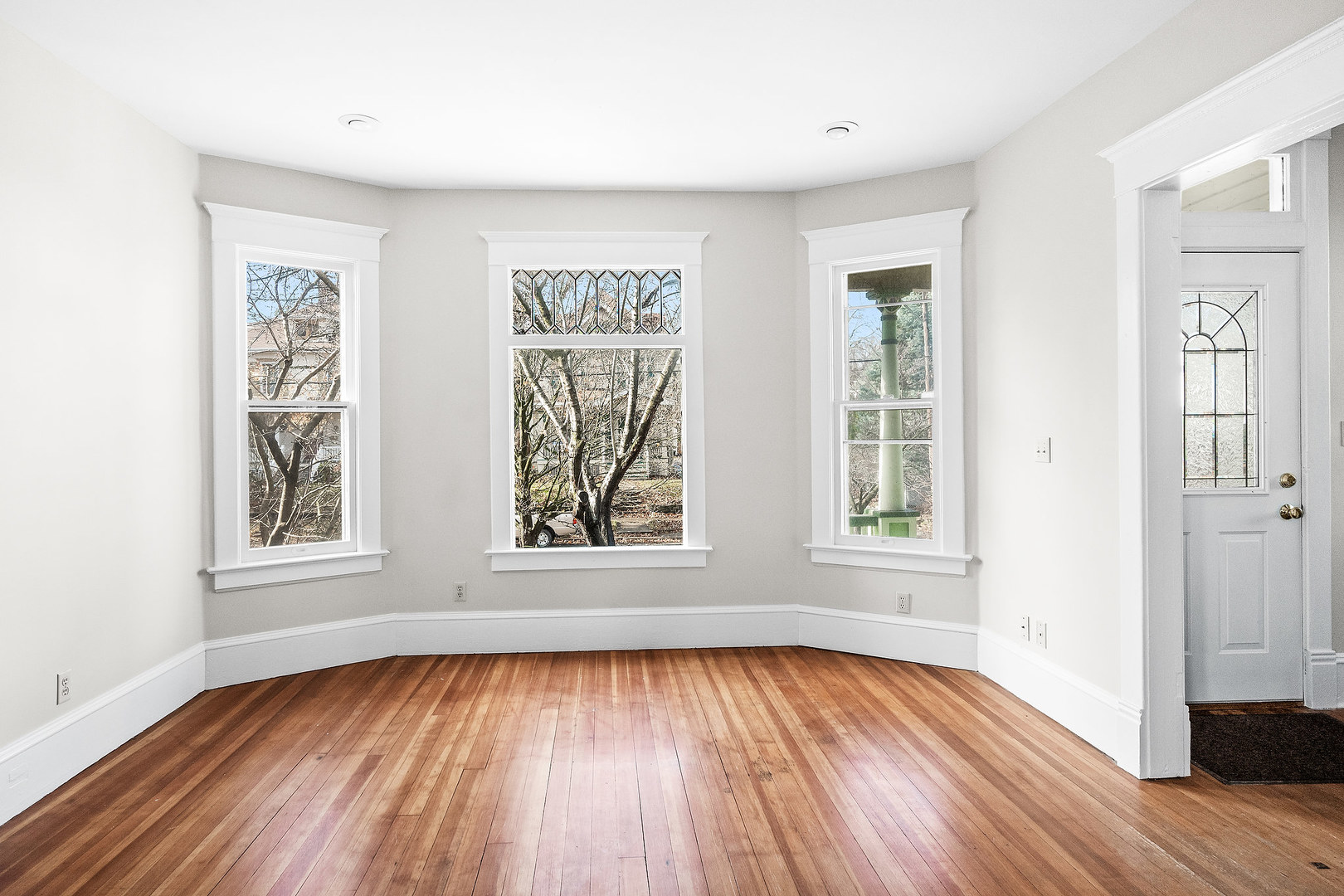 102 Vale Street Bloomington, IL 61701 - Photo 7 of 35 an empty room with wooden floor and windows