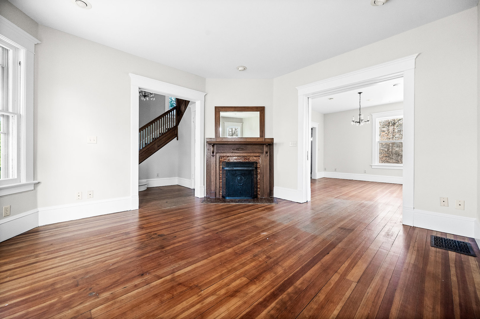 102 Vale Street Bloomington, IL 61701 - Photo 9 of 35 an empty room with wooden floor fireplace and windows