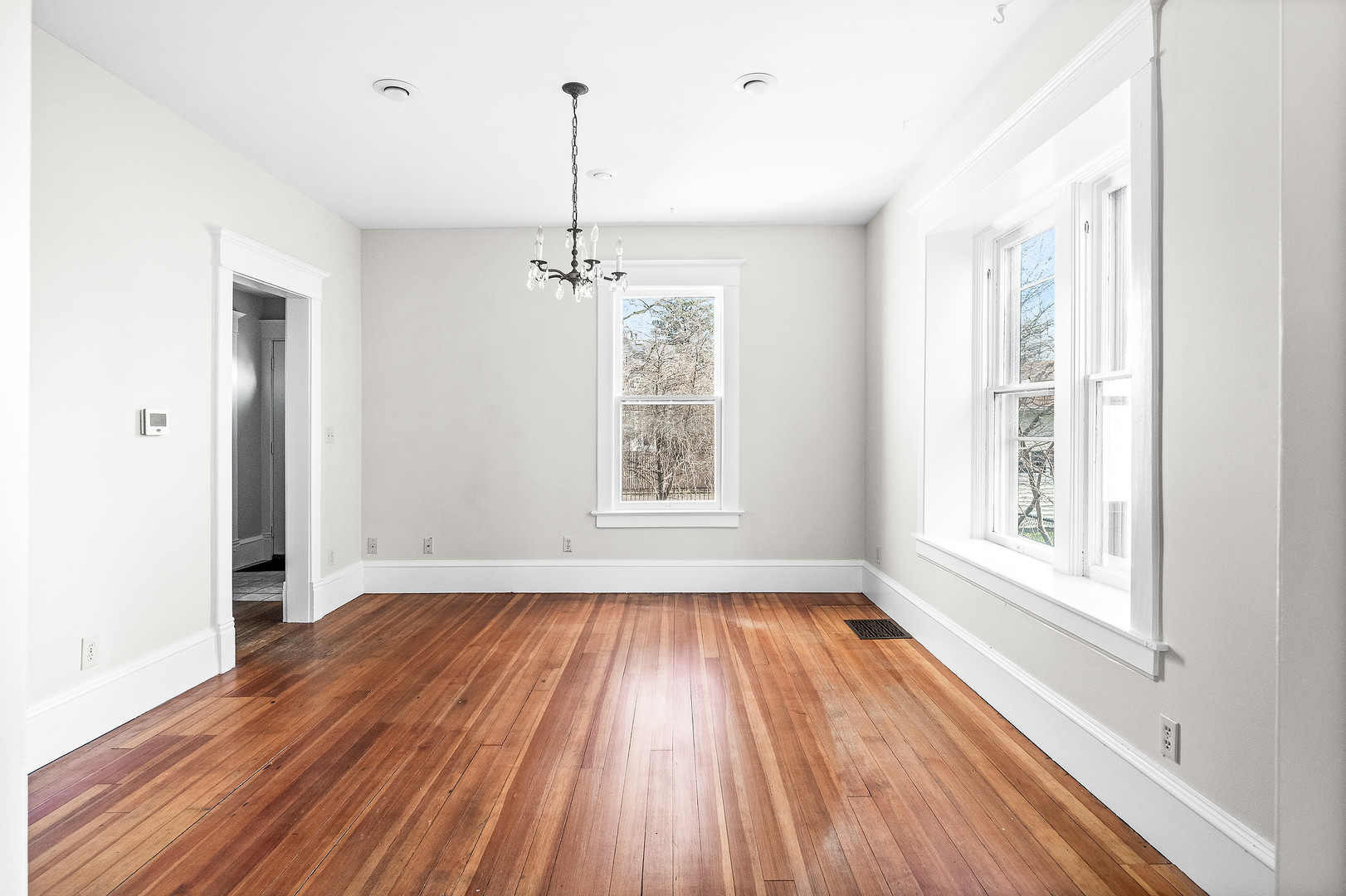 102 Vale Street Bloomington, IL 61701 - Photo 10 of 35 a view of an empty room with a window and wooden floor