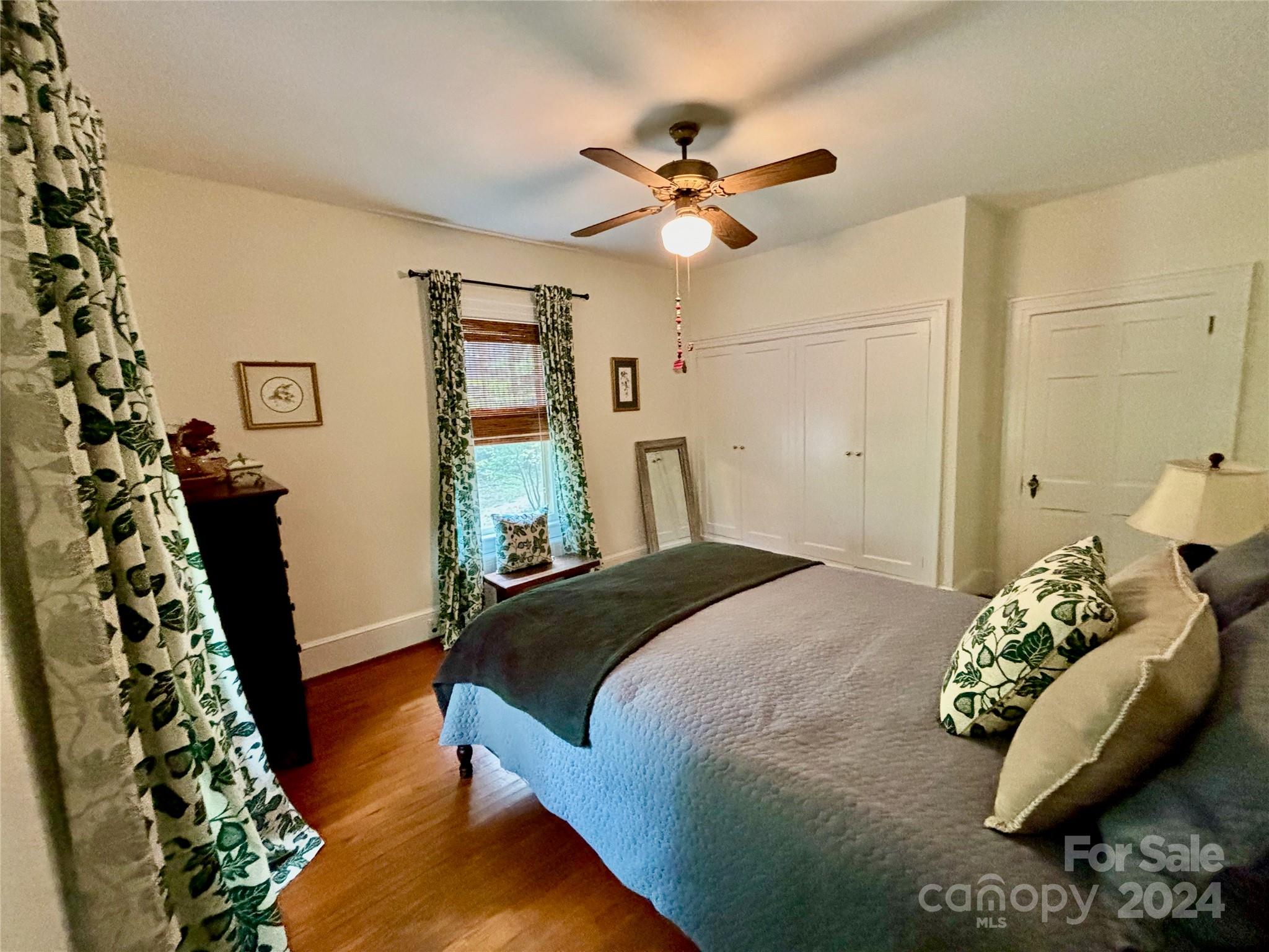 352 Chimney Rock Road Rutherfordton, NC 28139 - Photo 18 of 48 a bedroom with a bed and a chandelier