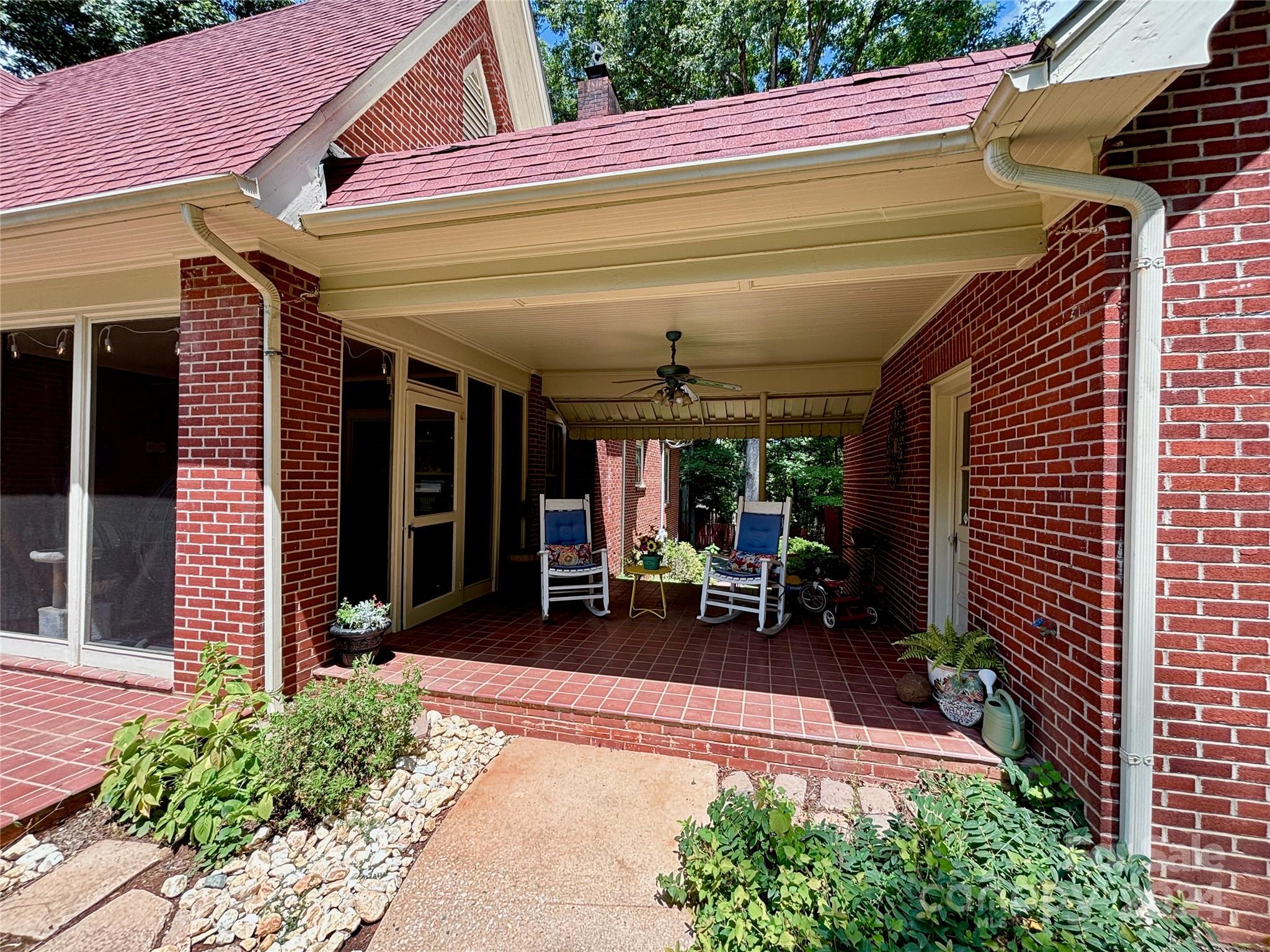 352 Chimney Rock Road Rutherfordton, NC 28139 - Photo 3 of 48 a view of a patio with table and chairs and potted plants