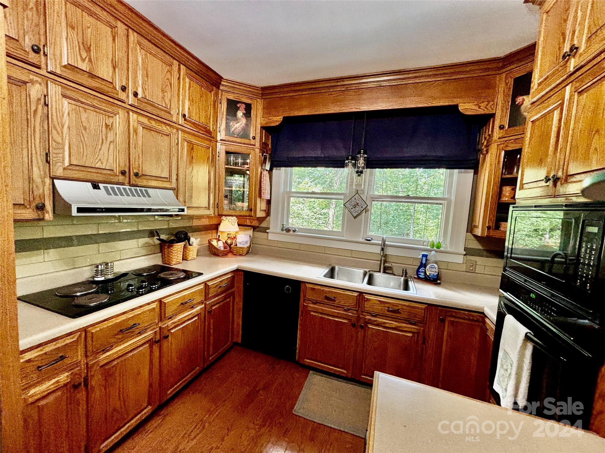 352 Chimney Rock Road Rutherfordton, NC 28139 - Photo 10 of 48 a kitchen with stainless steel appliances a sink stove and cabinets