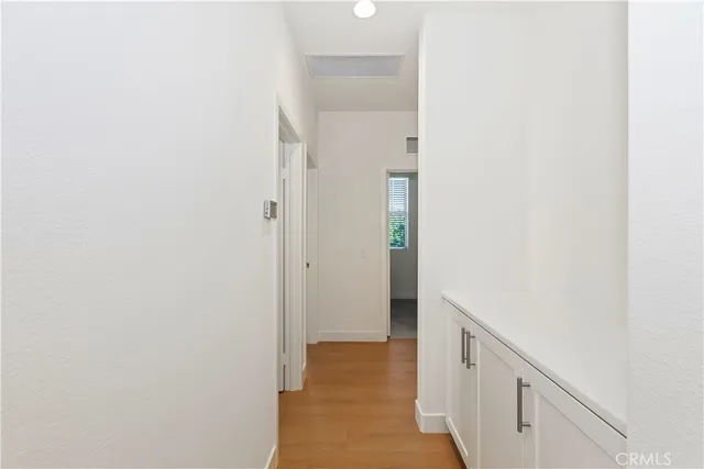 a view of a small space with wooden floor and a window