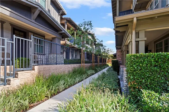 a view of a pathway of a house with a yard