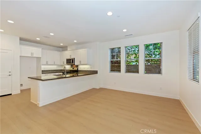 a kitchen with stainless steel appliances granite countertop a stove and a refrigerator