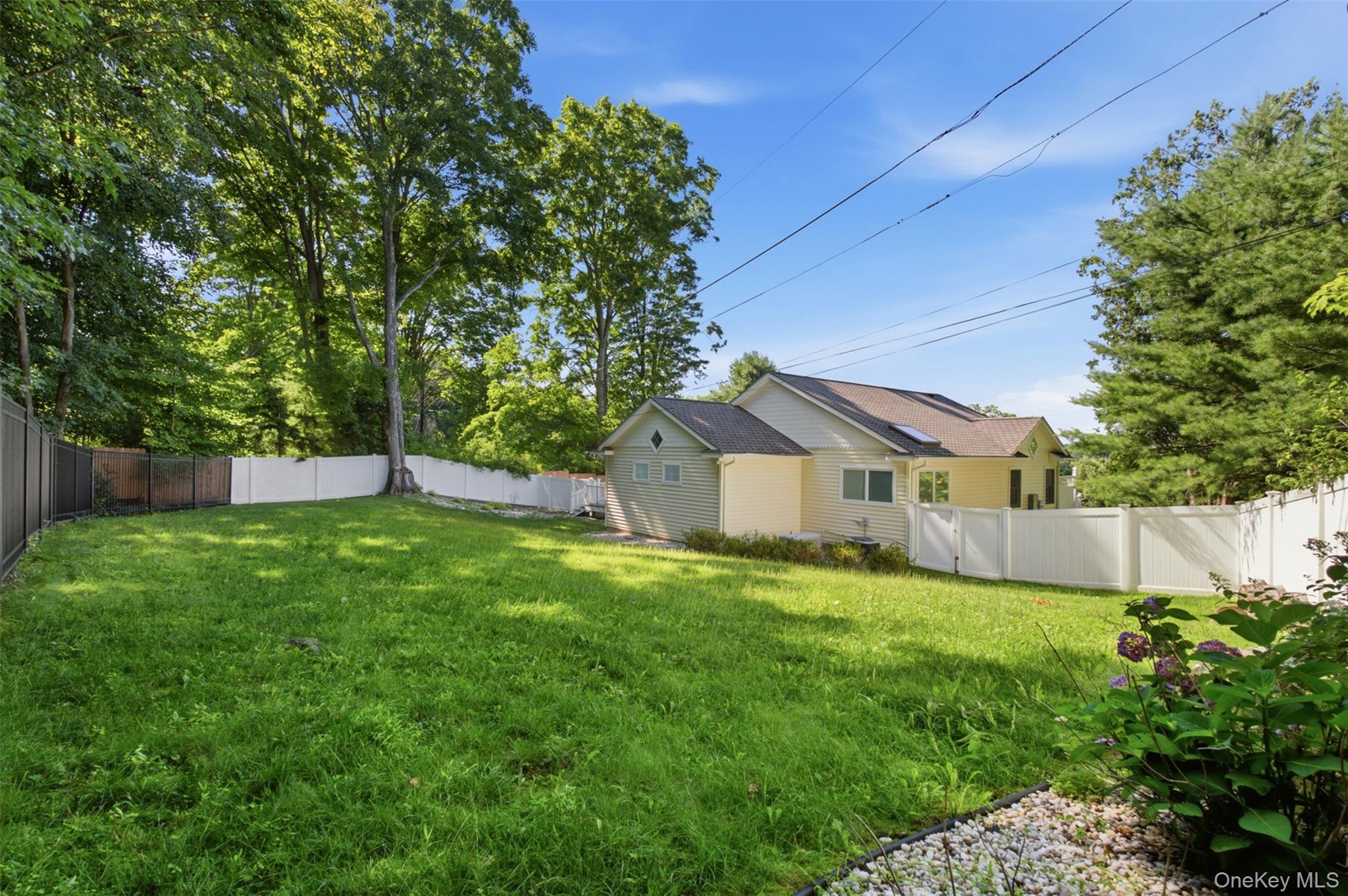 12 Leeside Road Carmel, NY 10512 - Photo 37 of 44 Spacious lawn area framed by a white privacy fence and mature trees