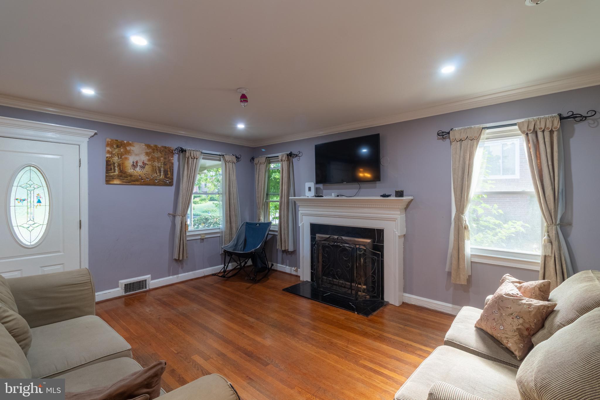 706 Forest Glen Road Silver Spring, MD 20901 - Photo 11 of 40 a living room with furniture and a fireplace