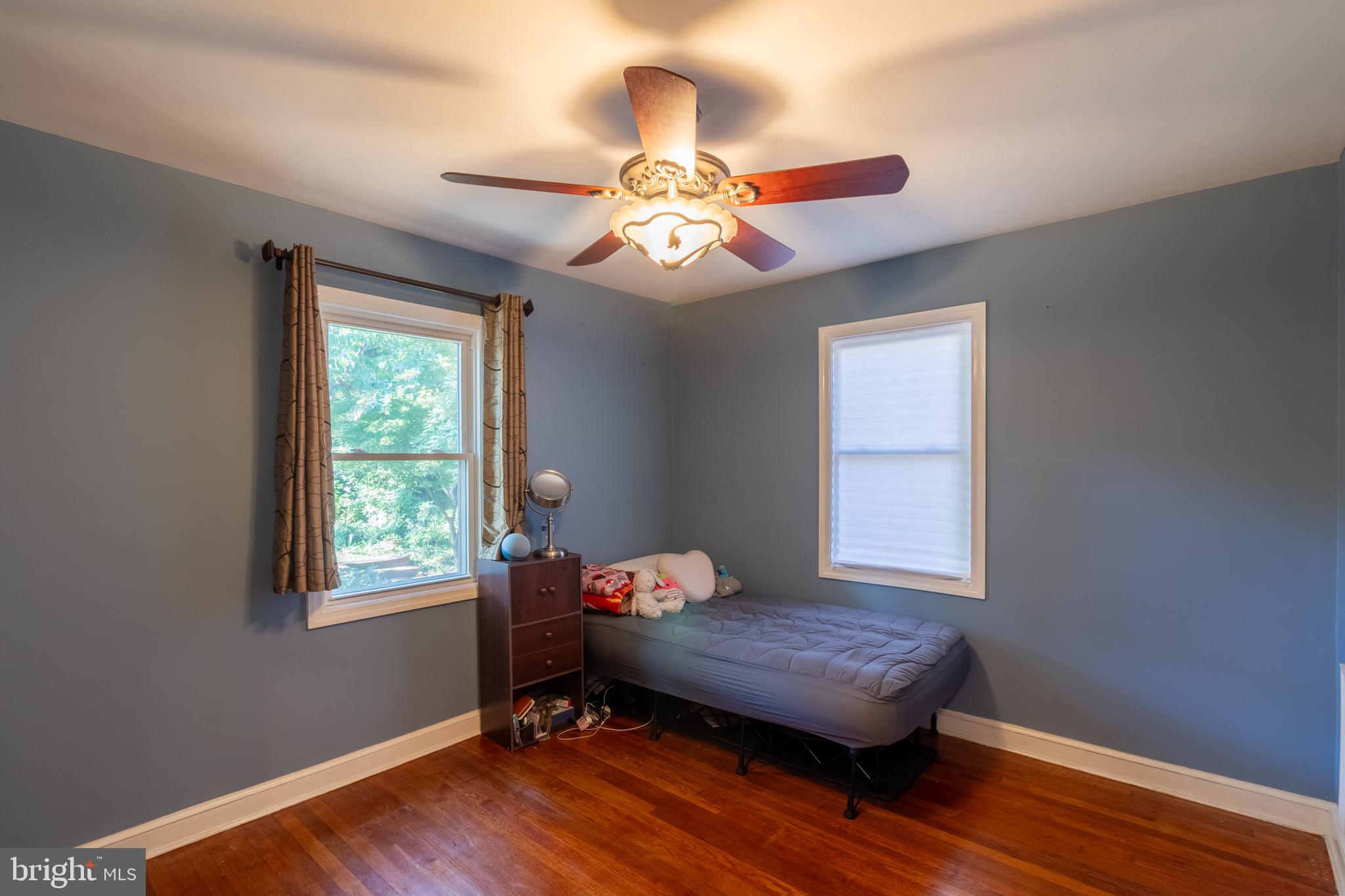 706 Forest Glen Road Silver Spring, MD 20901 - Photo 16 of 40 a bedroom with bed window and wooden floor
