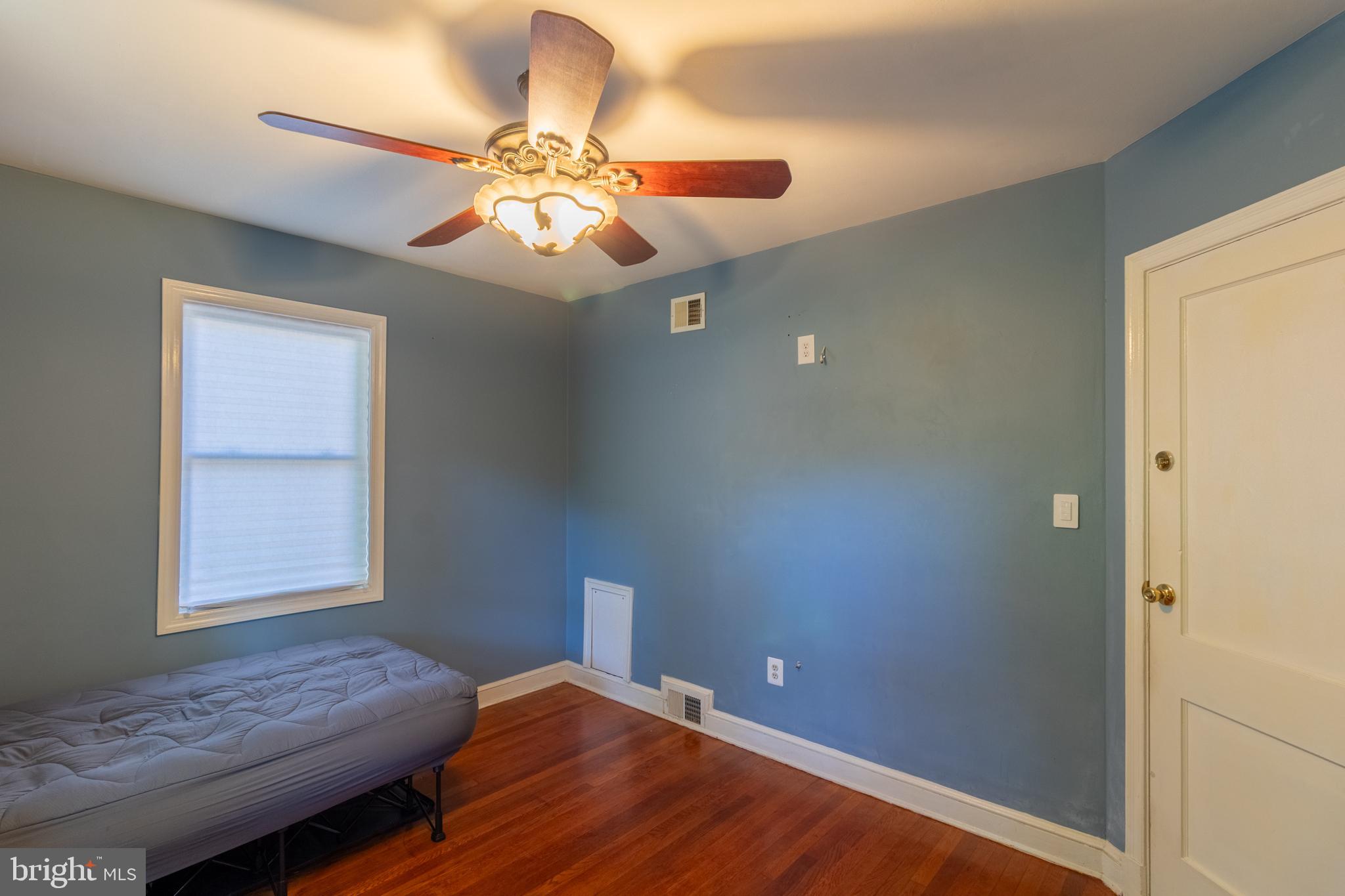 706 Forest Glen Road Silver Spring, MD 20901 - Photo 18 of 40 a bedroom with a bed and a chandelier