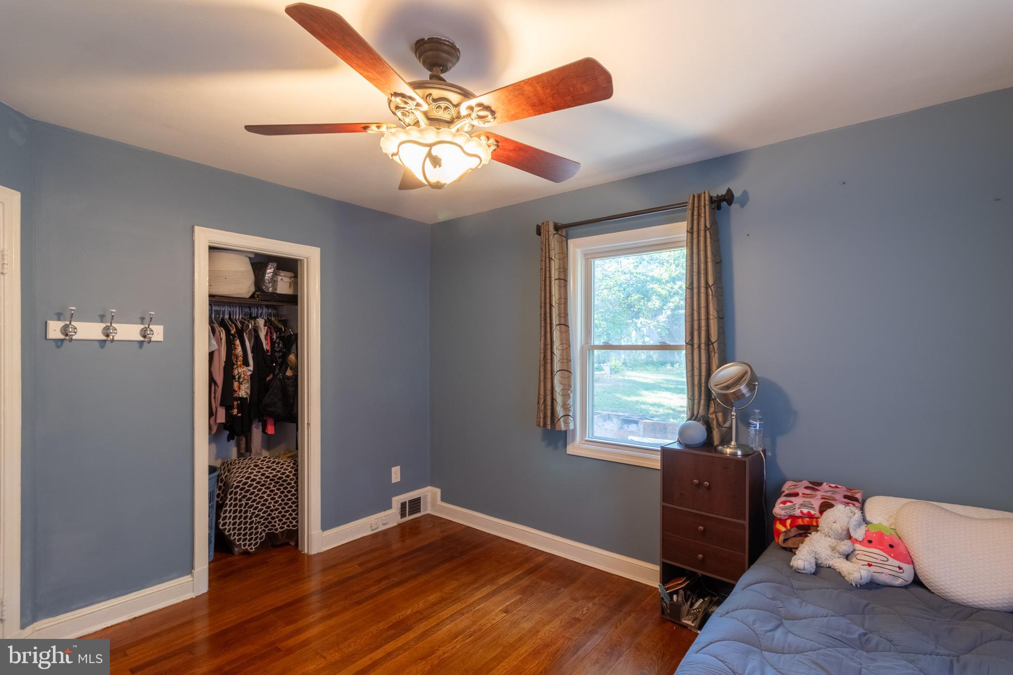 706 Forest Glen Road Silver Spring, MD 20901 - Photo 19 of 40 a view of a livingroom with wooden floor and a ceiling fan