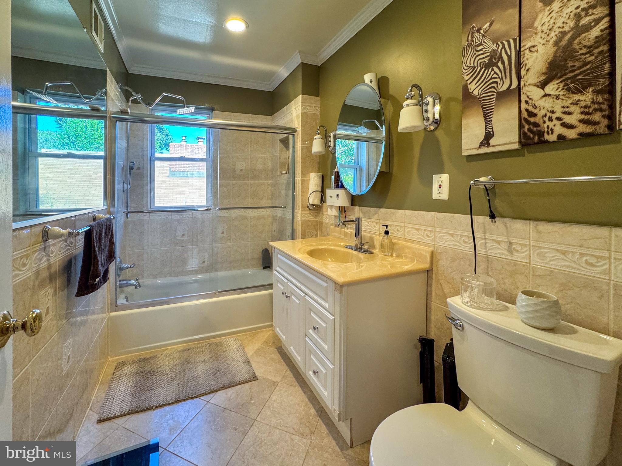 706 Forest Glen Road Silver Spring, MD 20901 - Photo 20 of 40 a bathroom with a double vanity sink toilet and shower