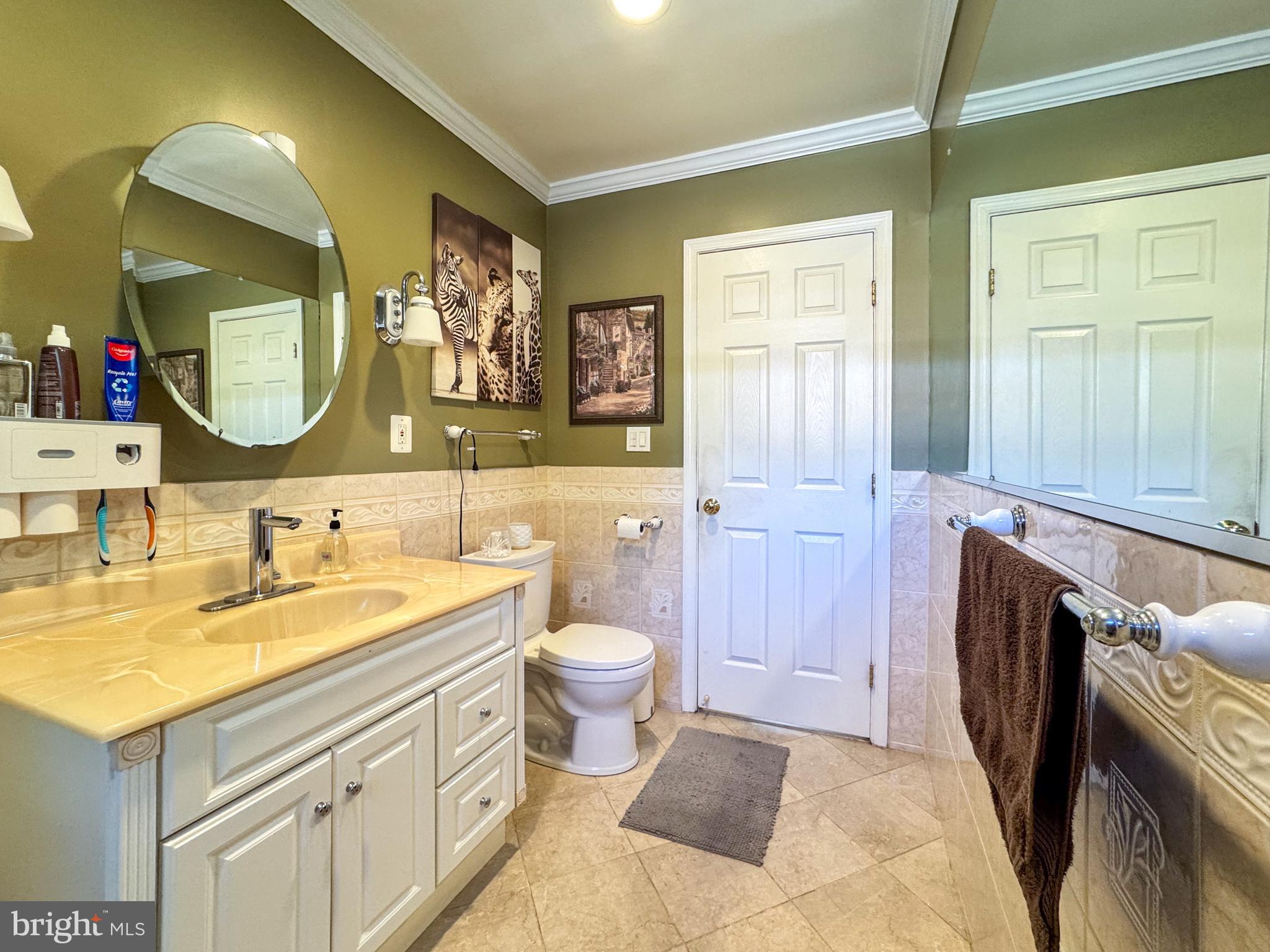 706 Forest Glen Road Silver Spring, MD 20901 - Photo 21 of 40 a bathroom with a sink and a mirror