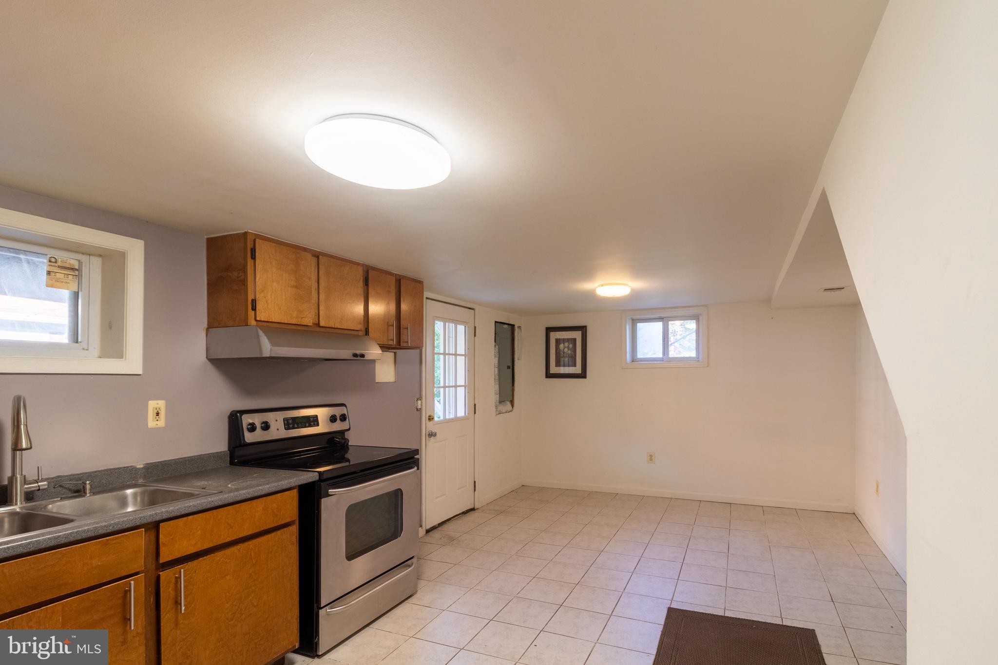 706 Forest Glen Road Silver Spring, MD 20901 - Photo 25 of 40 a kitchen with stainless steel appliances granite countertop a sink a stove a microwave a counter top space and cabinets