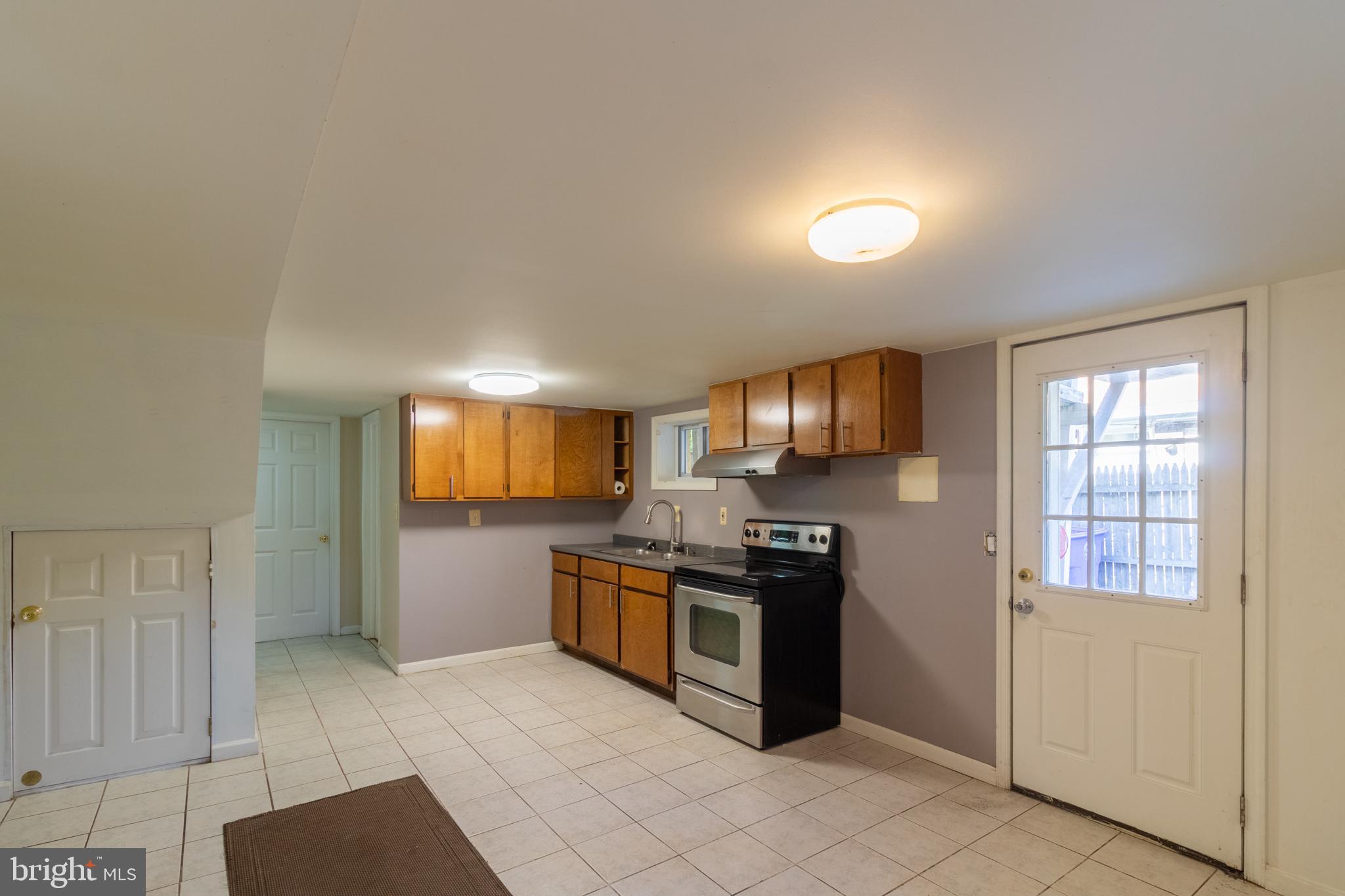 706 Forest Glen Road Silver Spring, MD 20901 - Photo 26 of 40 a kitchen with stainless steel appliances granite countertop a stove a sink and a refrigerator