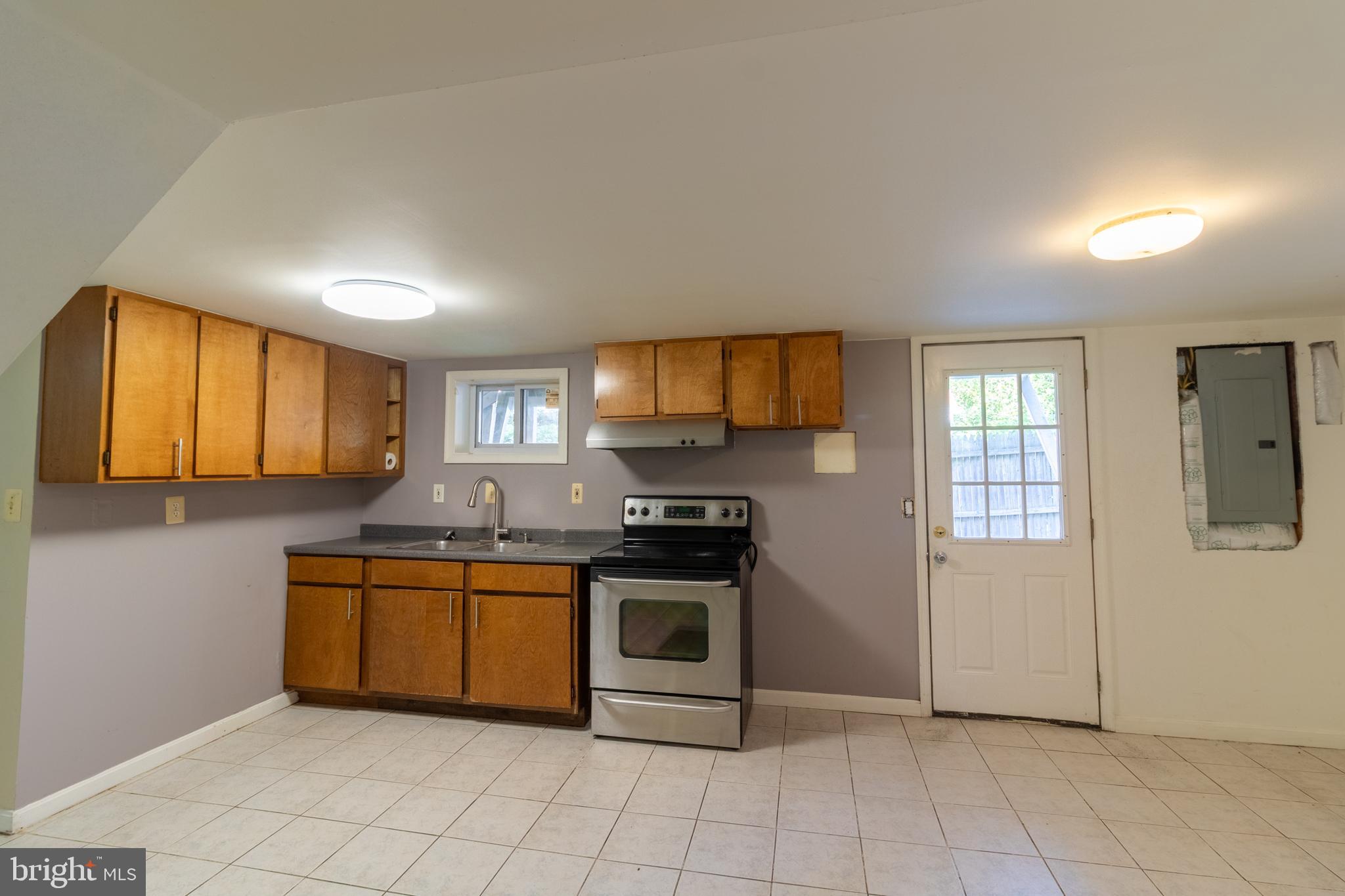 706 Forest Glen Road Silver Spring, MD 20901 - Photo 27 of 40 a kitchen with stainless steel appliances granite countertop a stove a sink and a refrigerator