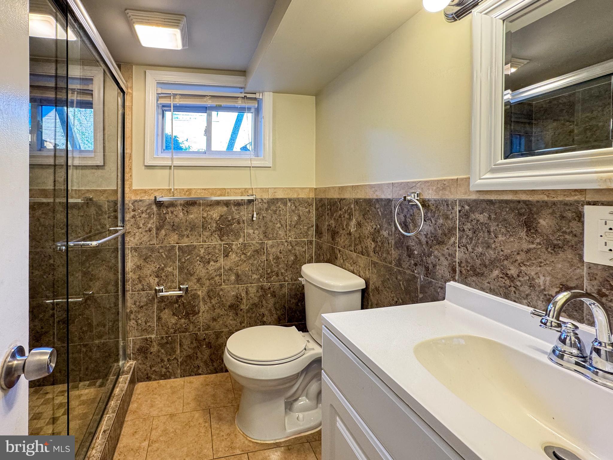 706 Forest Glen Road Silver Spring, MD 20901 - Photo 29 of 40 a bathroom with a toilet sink and mirror