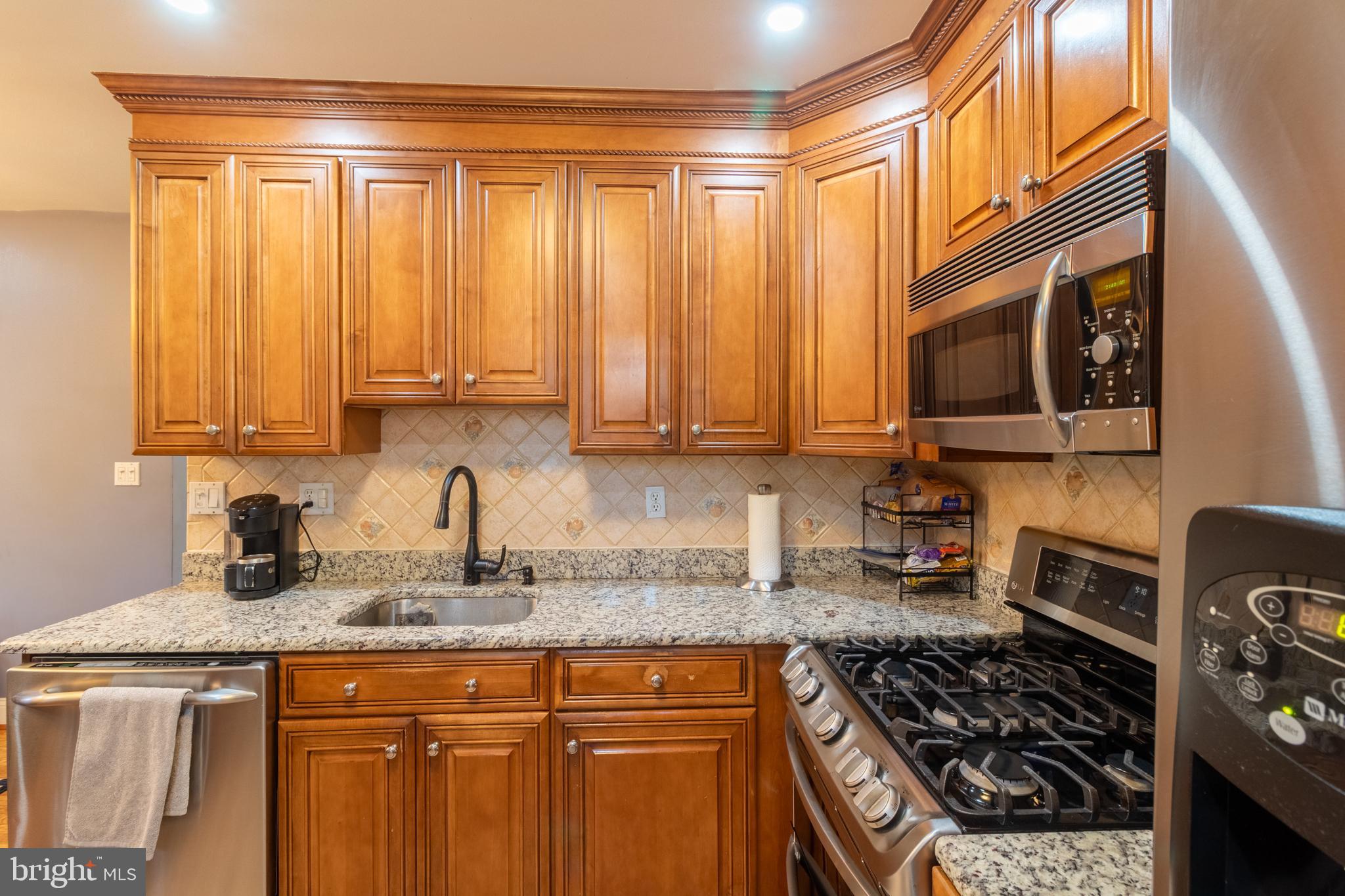 706 Forest Glen Road Silver Spring, MD 20901 - Photo 8 of 40 a kitchen with stainless steel appliances granite countertop a stove and a sink